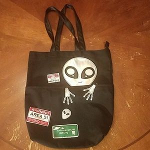 Black bag with alien design.